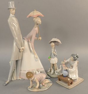 Four Llardo figures including large double figure having girl holding an umbrella, Oriental girl and two others. tallest 19 1/2 in.