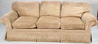 Light brown upholstered three cushion sofa. lg. 86 in. Provenance: Former home of Mel Gibson, Old Mill Rd, Greenwich, CT