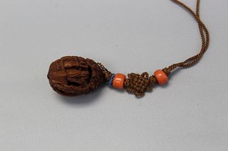 A carved walnut toggle.