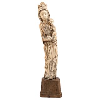 Virgin with Child. Europe. 19th Century. Carved ivory on wooden base.