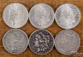 Six Morgan silver dollars, to include two 1884 O, UNC, an 1891, AU, an 1892 S, VG, and two 1894 O