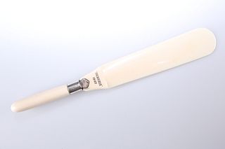 AN EDWARDIAN SILVER-MOUNTED IVORY PAGE TURNER, the silver collar with rubbe