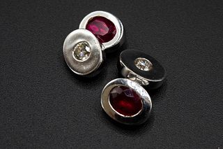 A PAIR OF RUBY AND DIAMOND WHITE GOLD CUFFLINKS, each pair set with an oval