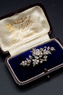 A LATE VICTORIAN DIAMOND SET SPRAY BROOCH, the central flower head mount be