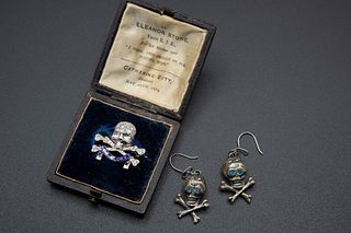A ROYAL LANCERS MILITARY DIAMOND AND ENAMEL BROOCH, the skull and cross bon