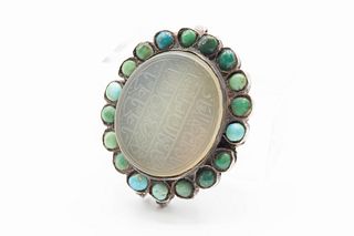 AN ENGRAVED JADEITE AND TURQUOISE BEAD CLASP, possibly Tibetan, the oval ca