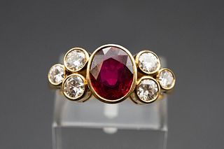 AN 18CT YELLOW GOLD RUBY AND DIAMOND COCKTAIL RING, the oval cut ruby set b