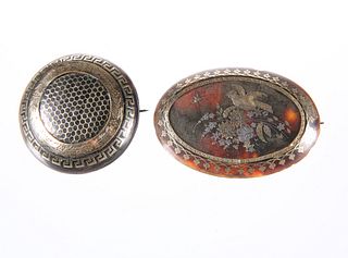 TWO 19TH CENTURY GOLD AND SILVER INLAID BROOCHES, the first oval, decorated