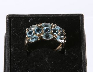 A 9 CARAT GOLD AND AQUAMARINE DRESS RING, set with five round-cut and six o
