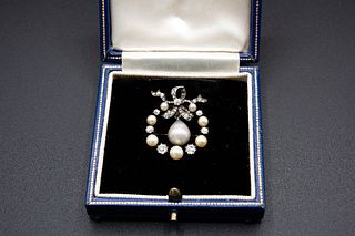 A DIAMOND AND NATURAL PEARL BROOCH, the wreath style mount with bow detail,