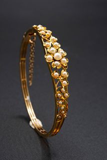 A SEED PEARL SET BANGLE, of split detail mount with foliage and flower head