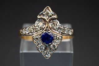 A SAPPHIRE AND DIAMOND RING, the crest shaped mount with diamond highlights