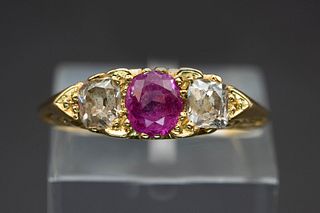 A LATE VICTORIAN RUBY AND DIAMOND RING, the single oval cut ruby and oval c