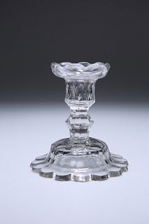 A GEORGE III CUT-GLASS CANDLESTICK, the domed base with petal edge. 11cm