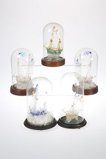 FIVE VICTORIAN GLASS FRIGGERS, each as a ship and under a glass dome with w