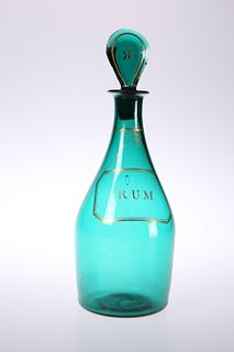 AN EARLY 19TH CENTURY GREEN GLASS RUM DECANTER, with gilded label, the flat