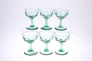 A SET OF SIX LATE VICTORIAN GREEN-GLASS CHAMPAGNE BOWLS, each with panel-cu