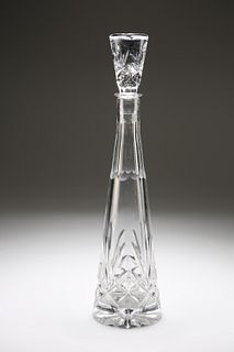 A CUT-GLASS SPIRE DECANTER, the tapering stopper with foliate band over a p
