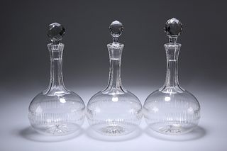 A SET OF THREE VICTORIAN GLOBE DECANTERS, each with ribbed body and panelle