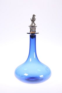 A 19th CENTURY BLUE GLASS DECANTER, with elongated neck and white metal sto