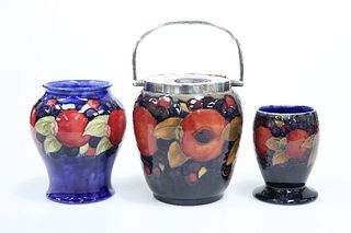 THREE PIECES OF MOORCROFT POTTERY IN THE POMEGRANATE PATTERN, comprising: a