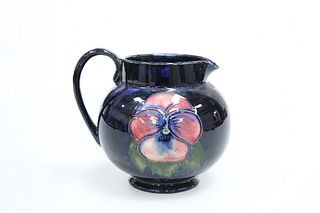 A MOORCROFT POTTERY JUG, tubelined and hand-painted with pansies, impressed