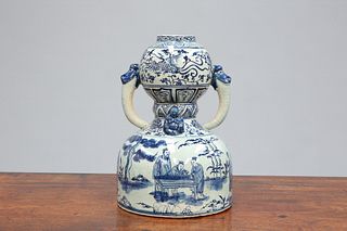 A CHINESE BLUE AND WHITE TWO-HANDLED GOURD VASE, applied with two Buddhas t