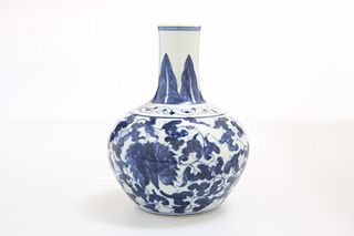 A CHINESE BLUE AND WHITE PORCELAIN BOTTLE VASE, painted with scrolling flow