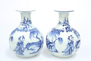 A LARGE PAIR OF CHINESE BLUE AND WHITE VASES, each decorated with figures i