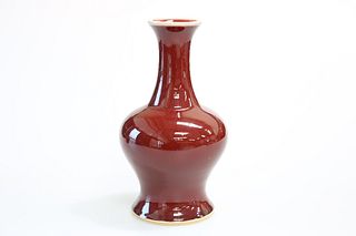 TWO CHINESE OXBLOOD GLAZE PORCELAIN VASES: the first of baluster form with 