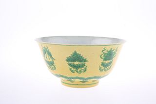 A CHINESE YELLOW GROUND AND GREEN DECORATED BOWL, painted with a series of 