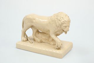 A STAFFORDSHIRE SALT-GLAZED MODEL OF A LION, 19TH CENTURY,   

naturalistic