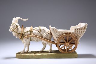 A ROYAL DUX MODEL OF A HARNESSED GOAT AND CART, modelled upon a grassy base