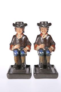 A PAIR OF CONTINENTAL POTTERY TOBY CHAMBERSTICKS, LATE 19TH CENTURY, impres