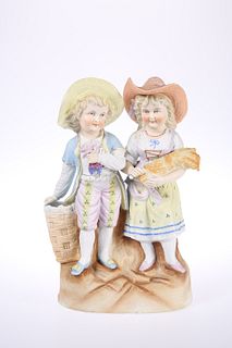 A CONTINENTAL BISQUE PORCELAIN FIGURE GROUP, CIRCA 1900, the boy and girl m