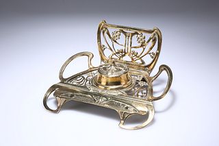 AN ART NOUVEAU BRASS INKSTAND, pierced and chased with whiplash and stylise