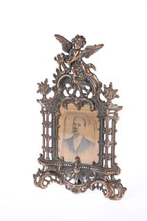 A VICTORIAN PATINATED METAL PHOTOGRAPH FRAME, in the Rococo taste, the scro