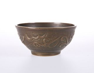 A SMALL ISLAMIC COPPER BOWL, probably 19th Century, decorated in low relief