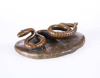 AN UNUSUAL PATINATED METAL MODEL OF A SNAKE, CIRCA 1900, modelled on a shap