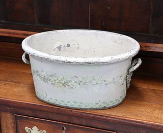 A REGENCY GREEN TOLE FOOTBATH, oval, painted with foliage. 47cm