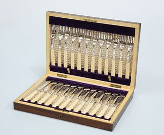 A SET OF TWELVE VICTORIAN SILVER-PLATED AND IVORY-HANDLED FISH KNIVES AND F