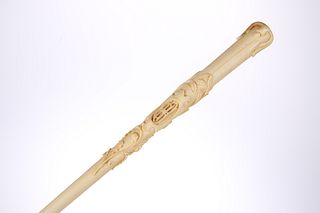 A 19TH CENTURY IVORY-HANDLED PARASOL, carved in relief with musical trophy,