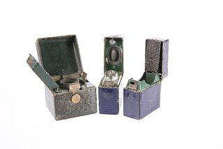 THREE EDWARDIAN TRAVELLING INKWELLS, each leather covered and with working 