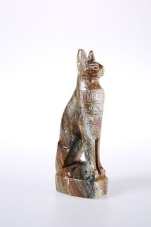 A CARVED STONE MODEL OF A SEATED CAT IN EGYPTIAN STYLE. 16.5cm