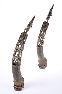 A PAIR OF BENIN BRONZE ROYAL HEAD TRUMPETS, each pierced and cast with figu