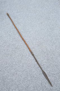 TRIBAL: A SPEAR, with barbed neck and arrow-shaped head. 157.5cm