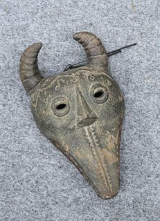TRIBAL: A MASK, carved with horns and teeth. 30cm
