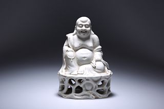 A CHINESE BLANC DE CHINE PORCELAIN FIGURE OF A SEATED BUDDHA, modelled hold