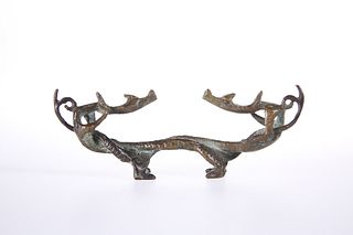 A CHINESE BRONZE BRUSH REST, cast as opposing entwined dragons, probably 19
