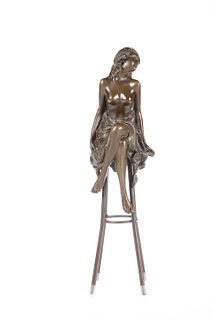 A BRONZE FIGURE OF A SEMI-NUDE MAIDEN, cast seated on a stool. 27cm